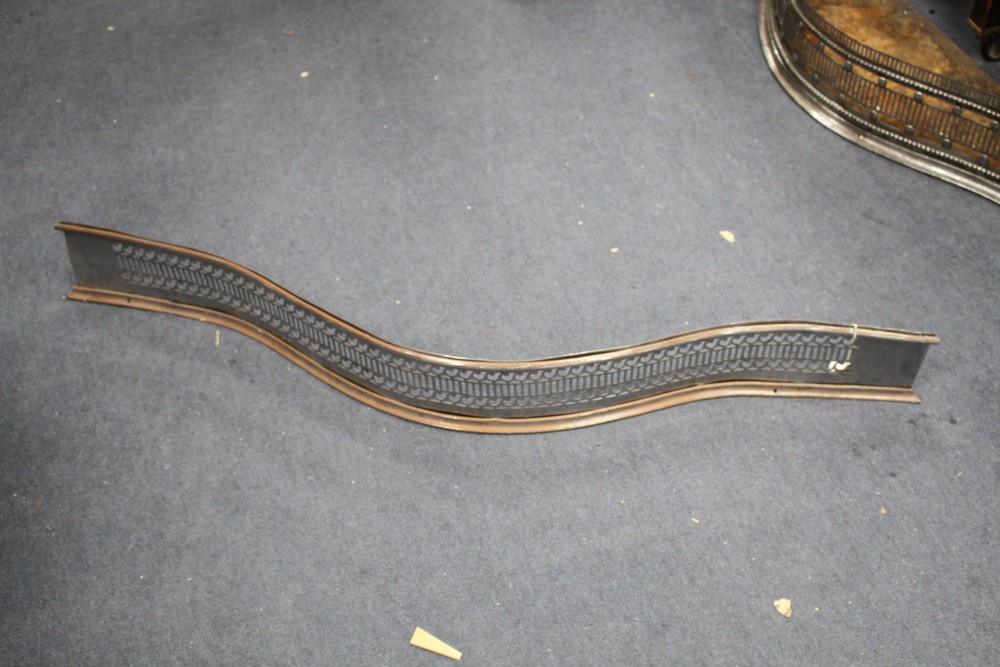 A George III cut steel fender, W.116cm, two other fenders and four assorted brass jardinieres
